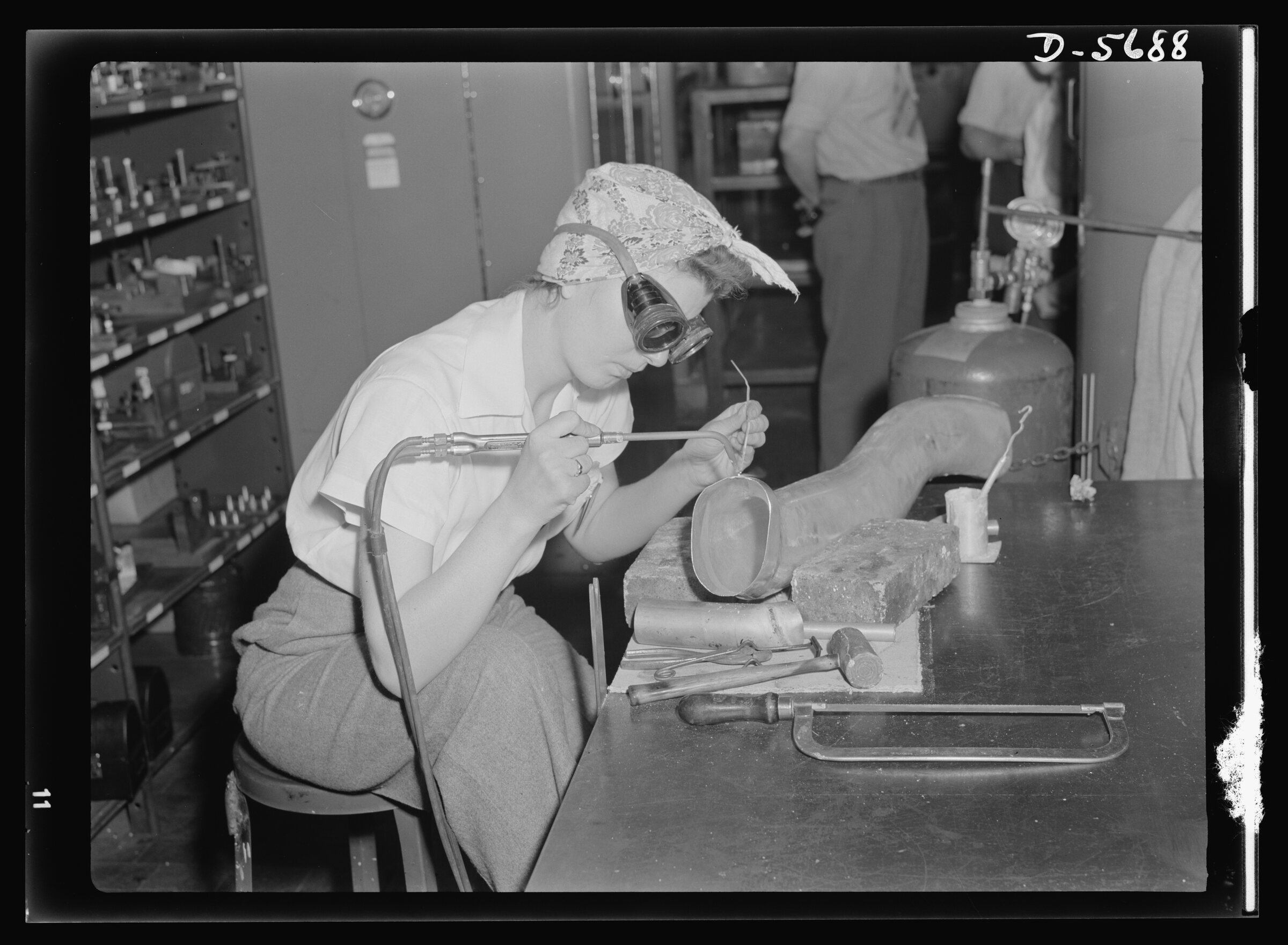 A woman production worker welds cooling-system parts to an aircraft supercharger at Ford’s Willow Run plant in Michigan in 1942.
